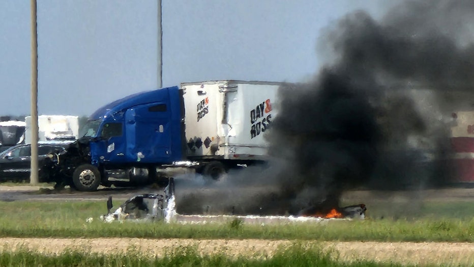 Smoke comes out of a car following a road accident that left 15 dead near Carberry, west of Winnipeg, Canada on June 15, 2023. (Photo by NIRMESH VADERA/AFP via Getty Images)