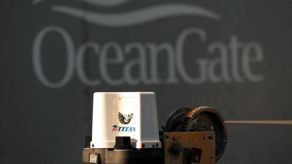 A decal on a piece of equipment which reads "Titan" is pictured near a trailer with the OceanGate logo at OceanGate Expeditions headqurters in the Port of Everett Boat Yard in Everett, Washington, on June 22, 2023. (Photo by JASON REDMOND/AFP via Getty Images)