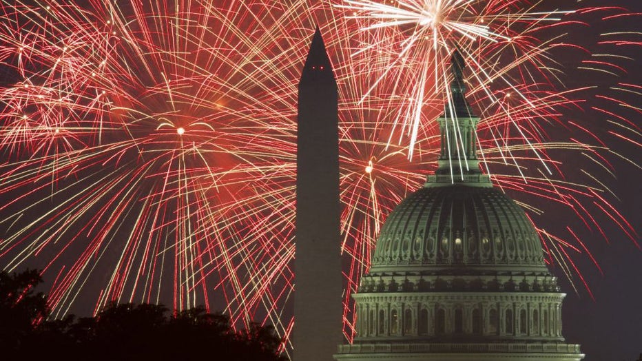 FILE - Fireworks explode over the National Mall as the US Capitol (R) and National Monument are seen on July 4, 2017, in Washington, DC. (Photo by PAUL J. RICHARDS/AFP via Getty Images)