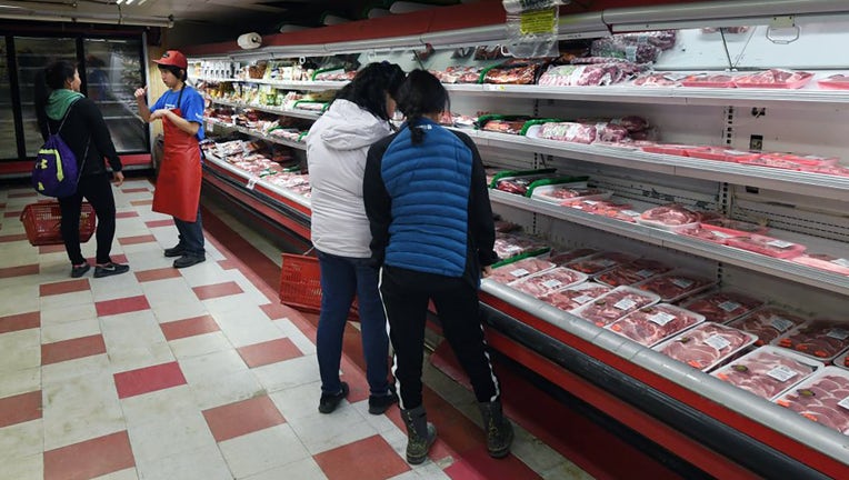 FILE - People shop for food at a supermarket in the town of Bethel on the Yukon Delta, Alaska on April 17, 2019. (Photo credit: MARK RALSTON/AFP via Getty Images)