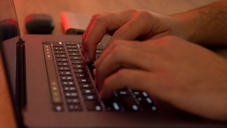 FILE - Mans hands are seen typing on an Apple laptop in Athens, Greece, on April 4, 2022. (Photo by Nikolas Kokovlis/NurPhoto via Getty Images)
