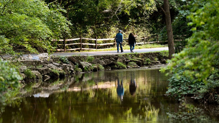 FILE - People walk along a paved portion of a trail on Sept. 15, 2020, in Wyomissing, PA. (Photo by Ben Hasty/MediaNews Group/Reading Eagle via Getty Images)