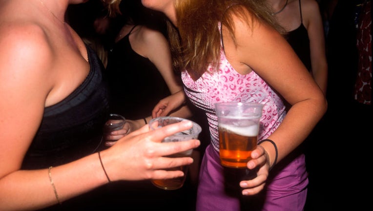 FILE - Girls drinking alcohol and dancing. (Photo by PYMCA/Avalon/Getty Images)