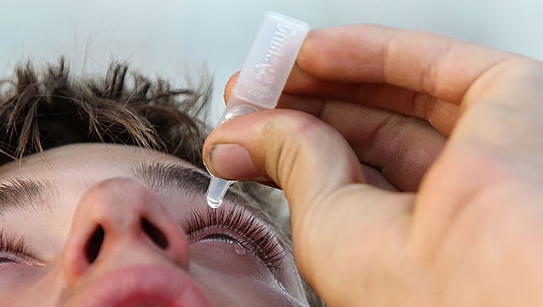 FILE - A person uses eyedrops on November 24, 2011, in Margaret River, Australia. (Photo by Will Russell/Getty Images)