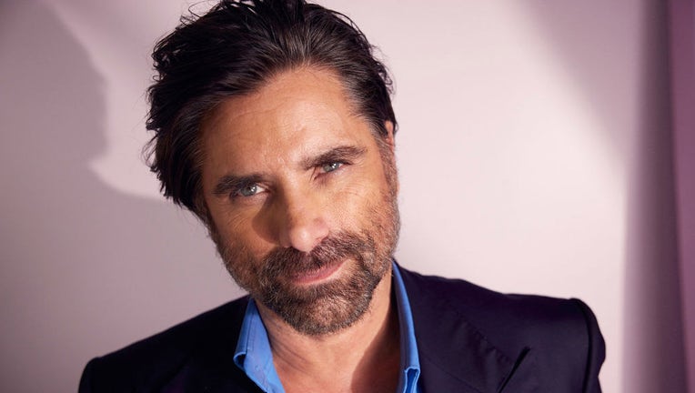 FILE - John Stamos poses at the IMDb Official Portrait Studio during D23 2022 at Anaheim Convention Center on Sept. 10, 2022, in Anaheim, California. (Photo by Corey Nickols/Getty Images for IMDb)