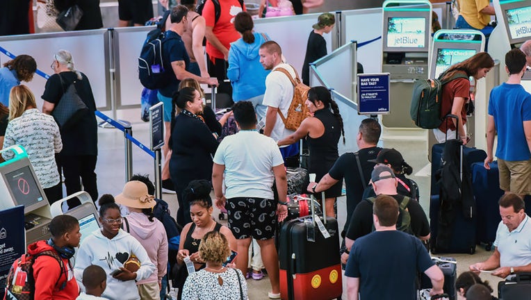 FILE - Travelers wait to check in for their flight at a JetBlue ticket counter at Orlando International Airport during the busy Labor Day 2023 holiday weekend in Orlando, Florida. (Photo by Paul Hennessy/SOPA Images/LightRocket via Getty Images)