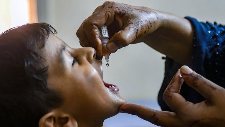 FILE - A health worker administers polio drops to a child during a door-to-door vaccination campaign in Karachi on Oct. 2, 2023. (Photo by RIZWAN TABASSUM/AFP via Getty Images)