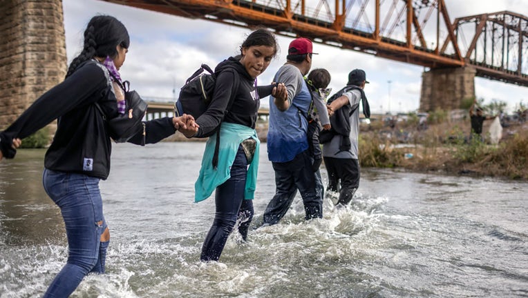 FILE - Immigrants from Venezuela cross the Rio Grande from Mexico into the United States on Sept. 30, 2023, in Eagle Pass, Texas. (Photo by John Moore/Getty Images)