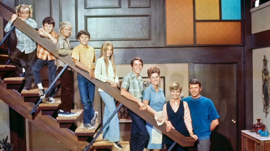 FILE - The Brady Bunch. 1969. From the top of the stairs down, Susan Olsen (as Cindy Brady); Mike Lookinland (as Bobby Brady); Eve Plumb (as Jan Brady); Christopher Knight (as Peter Brady); Maureen McCormick (as Marcia Brady); Barry Williams (as Greg Brady); Ann B. Davis (as Alice Nelson); Florence Henderson (as Carol Brady); and Robert Reed (as Mike Brady). (Photo by CBS via Getty Images)