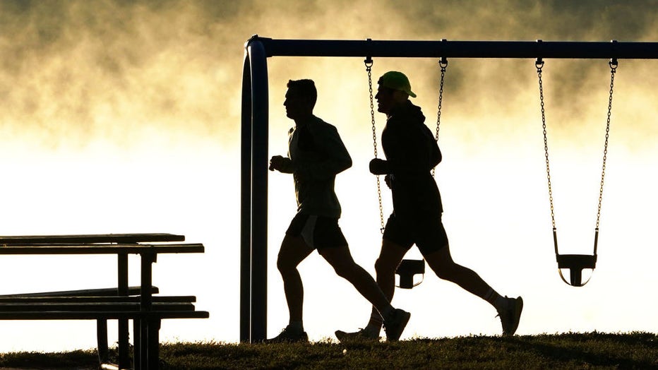 FILE - Runners make their way by playground equipment on Sept. 28, 2022, in Minneapolis, Minn. (Photo by David Joles/Star Tribune via Getty Images)