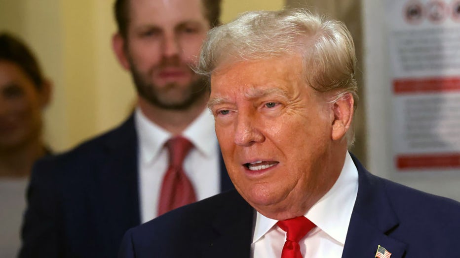 Eric Trump stands behind his father former U.S. President Donald Trump as he speaks to the media on the third day of his civil fraud trial at New York State Supreme Court on Oct. 4, 2023, in New York City. (Photo by Spencer Platt/Getty Images)