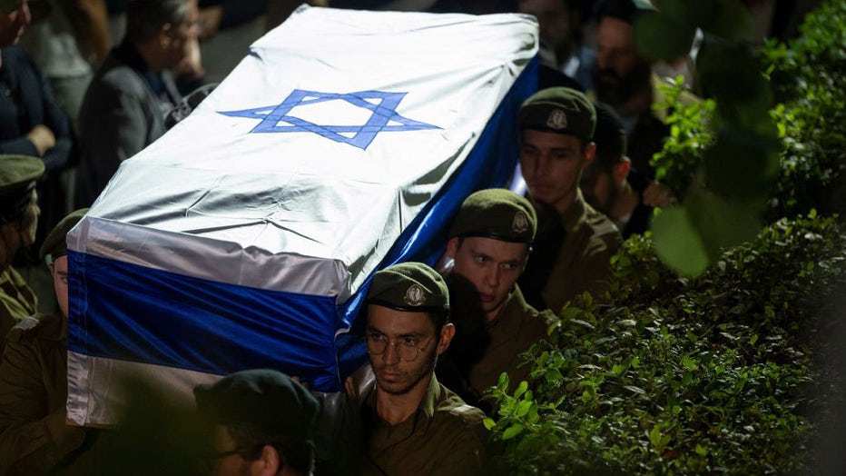 Israeli army soldiers carry the coffin with the remains of their comrade Noam Elimeleh Rothenberg during his funeral at Mount Herzl Cemetery in Jerusalem on Oct. 10, 2023. (Photo by YURI CORTEZ/AFP via Getty Images)