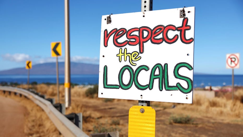 A sign reads "Respect the Locals" nearly two months after a devastating wildfire on Oct. 7, 2023, in Lahaina, Hawaii. (Photo by Mario Tama/Getty Images)