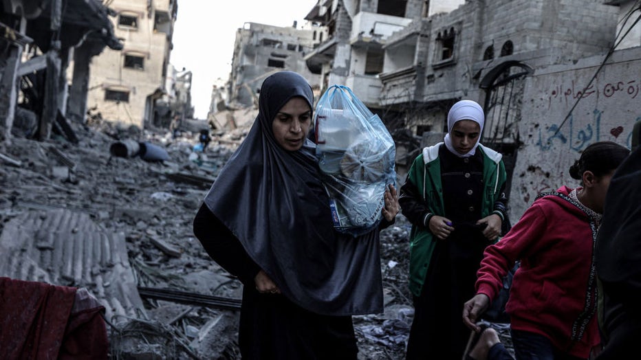 Palestinians carrying belongings flee to safer areas following Israeli bombardments on southern part of Gaza City, Tel al-Hawa neighborhood, Gaza on Oct. 16, 2023. (Photo by Ali Jadallah/Anadolu via Getty Images)