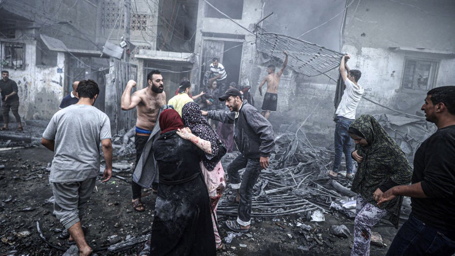 People try to rescue victims after Israeli airstrikes hit Ridwan neighborhood of Gaza City, Gaza on October 23, 2023. (Photo by Ali Jadallah/Anadolu via Getty Images)