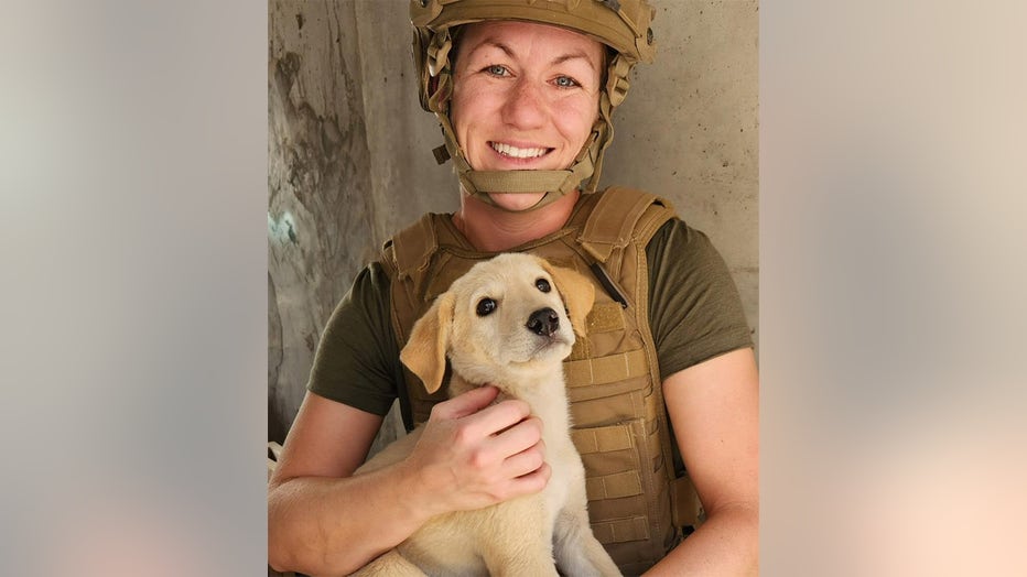 U.S. Navy sailor Joy and Koda are pictured on base. "I can't even imagine leaving her alone — she is my little comrade and you can't leave a comrade behind," Joy said. (Paws of War)