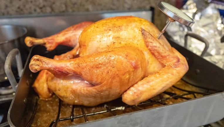 FILE - A cooked turkey in roasting pan with meat thermometer during the preparation of a traditional American Thanksgiving holiday meal in San Ramon, California, on Nov. 23, 2019. (Photo by Smith Collection/Gado/Getty Images)