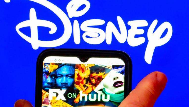 FILE - In this photo illustration, the FX on Hulu logo is displayed on a smartphone screen with a Disney logo in the background. (Photo Illustration by Igor Golovniov/SOPA Images/LightRocket via Getty Images)