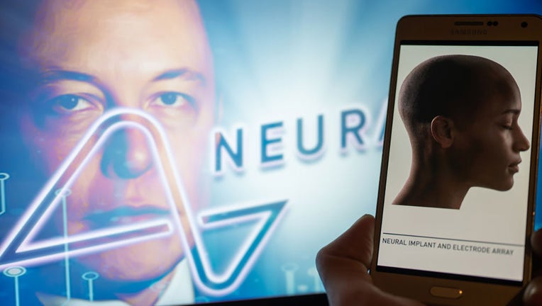 FILE - Neuralink logo displayed on a mobile with founder Elon Musk seen on screen in the background. (Photo Illustration by Jonathan Raa/NurPhoto via Getty Images)