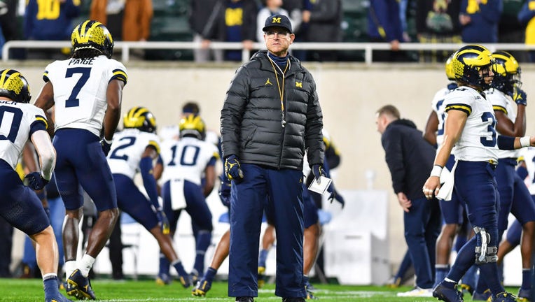 Michigan Wolverines head coach Jim Harbaugh watches his team warm up prior to a college football game between the Michigan State Spartans and Michigan Wolverines on Oct. 21, 2023, at Spartan Stadium in East Lansing, MI. (Photo by Adam Ruff/Icon Sportswire via Getty Images)