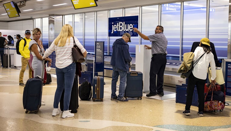 FILE - Travelers check bags at the JetBlue counter at Fort Lauderdale-Hollywood International Airport (FLL) in Fort Lauderdale, Florida, US, on Nov. 1, 2023. Photographer: Eva Marie Uzcategui/Bloomberg via Getty Images