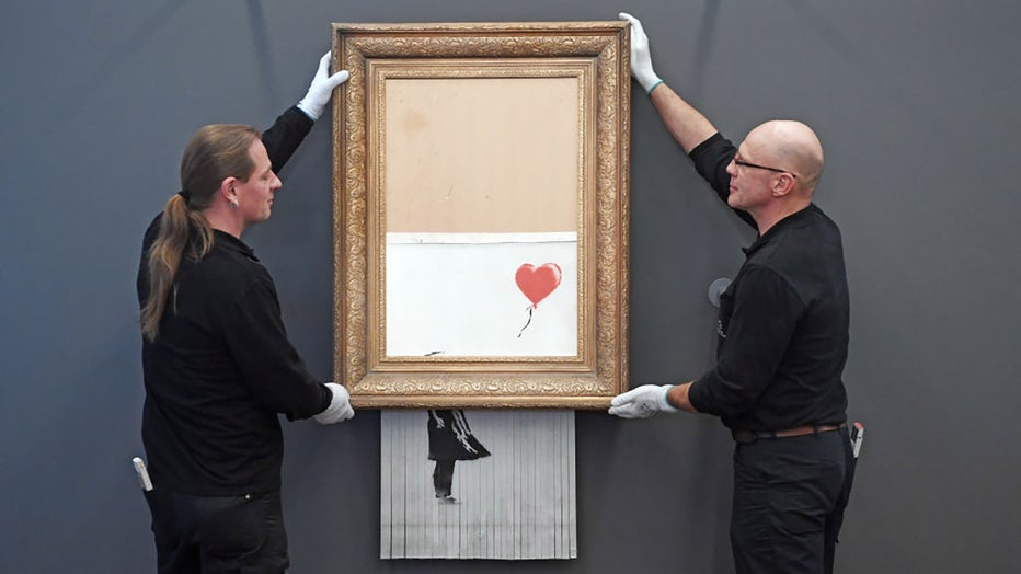 The shredded Banksy painting "Love is in the Bin" is hung in the Frieder Burda Museum in 2019. (Photo by Uli Deck/picture alliance via Getty Images)