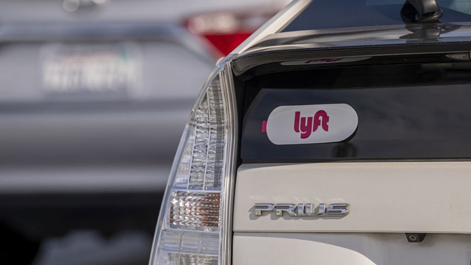 FILE - Lyft signage on a vehicle as it exits the ride-sharing pickup at San Francisco International Airport in San Francisco, California, on Feb. 3, 2022. Photographer: David Paul Morris/Bloomberg via Getty Images