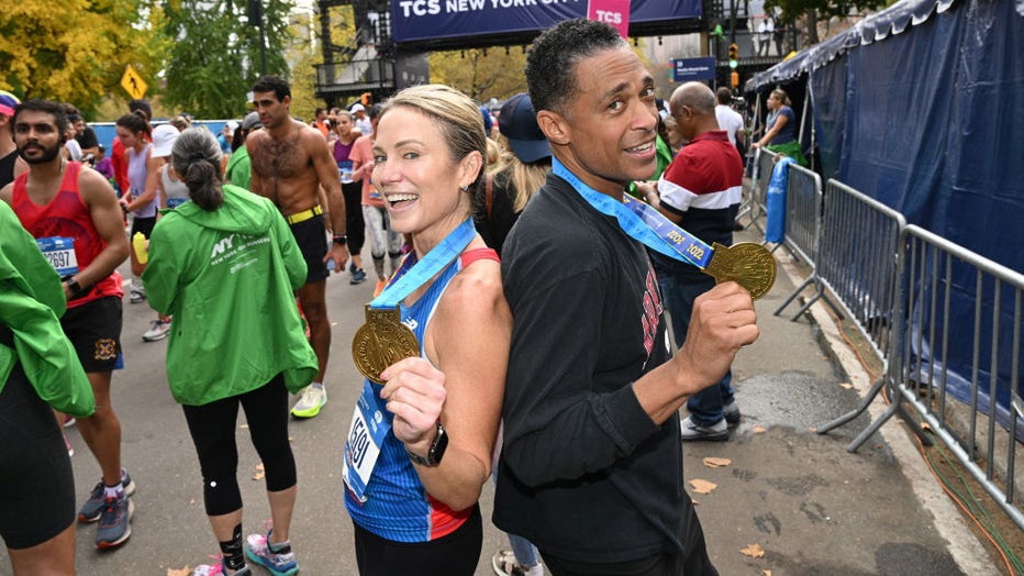 FILE - Amy Robach and TJ Holmes run during the 2022 TCS New York City Marathon on Nov. 6, 2022, in New York City. (Photo by Bryan Bedder/New York Road Runners via Getty Images)