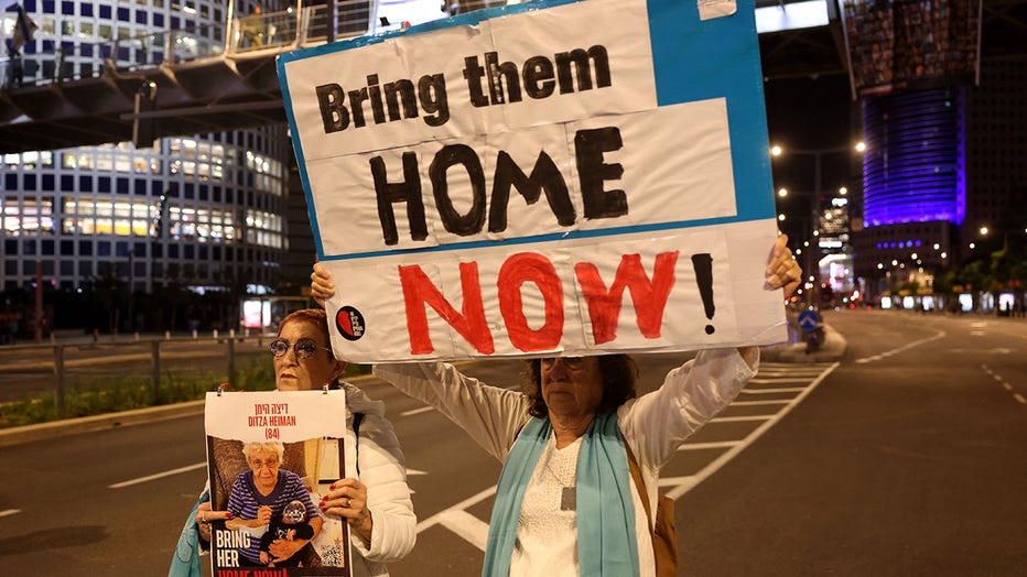 Families of Israeli hostages held by Palestinian militants in the Gaza Strip protest outside the ministry of defence in Tel Aviv calling on November 21, 2023, amid ongoing battles between Israel and the Palestinian armed group. (Photo by AHMAD GHARABLI/AFP via Getty Images)