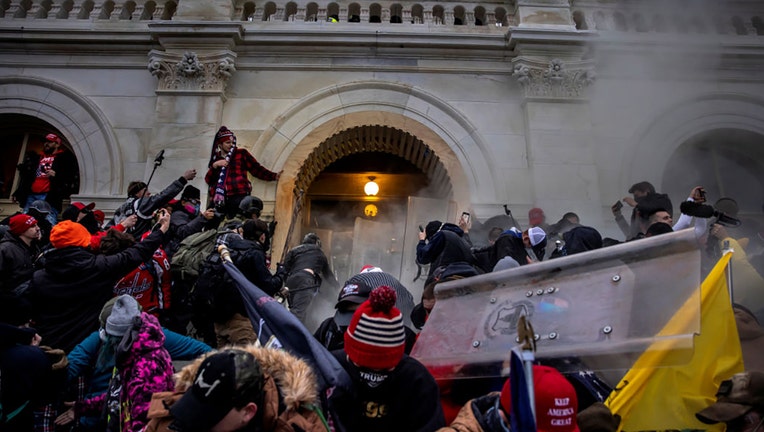 Trump supporters clash with police and security forces as people try to storm the US Capitol on Jan. 6, 2021, in Washington, DC. (Photo by Brent Stirton/Getty Images)