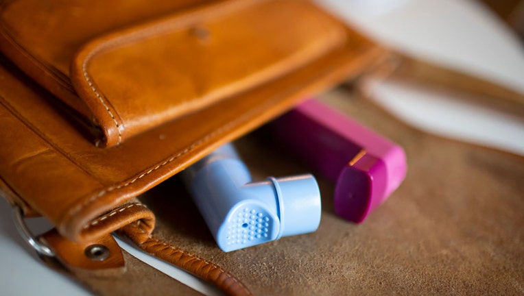 In this photo illustration, two asthma inhalers are pictured in a handbag on Feb. 3, 2021. (Photo by Ute Grabowsky/Photothek via Getty Images)