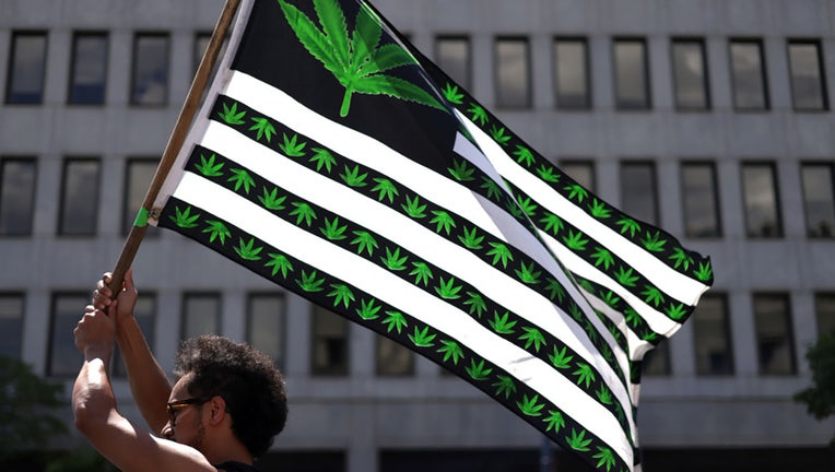 FILE - A marijuana activist holds a flag during a march on Independence Day on July 4, 2021, in Washington, D.C. (Photo by Alex Wong/Getty Images)