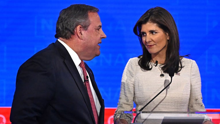 Former Governor of New Jersey Chris Christie (L) and former Governor from South Carolina and UN ambassador Nikki Haley speak during a break in the fourth Republican presidential primary debate at the University of Alabama in Tuscaloosa, Alabama, on Dec. 6, 2023. (Photo by Jim WATSON / AFP) (Photo by JIM WATSON/AFP via Getty Images)