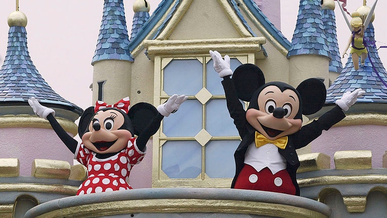 FILE - Disney characters Mickey Mouse and Minnie Mouse perform during the parade at Hong Kong Disneyland on Sept. 11, 2005, in Hong Kong. (Photo by MN Chan/Getty Images)