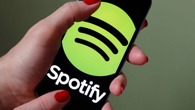 FILE - In this photo illustration, the logo of music streaming service Spotify is displayed on the screen of an iPhone on Jan. 6, 2017, in Paris, France. (Photo by Chesnot/Getty Images)