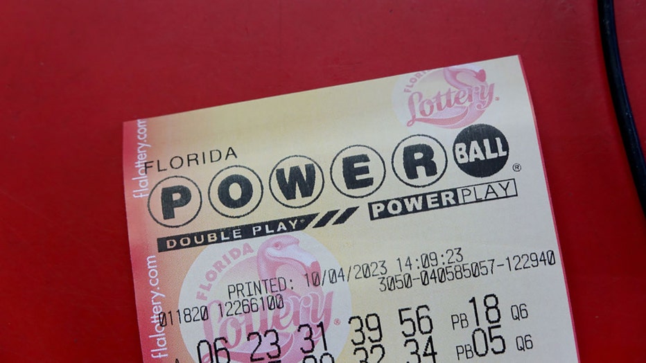 FILE - A Powerball ticket is seen on a counter after being purchased in a store on Oct. 4, 2023, in Miami, Florida. (Photo by Joe Raedle/Getty Images)