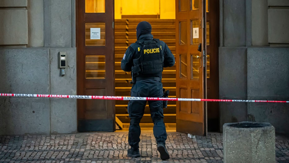 Police officer walks around the building of Philosophical Faculty of Charles University where a mass shooting took place on December 22, 2023 in Prague, Czech Republic. (Photo by Gabriel Kuchta/Getty Images)