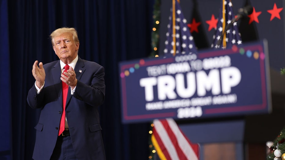 Republican presidential candidate and former U.S. President Donald Trump claps as he wraps up a campaign event on Dec. 19, 2023, in Waterloo, Iowa. (Photo by Scott Olson/Getty Images)