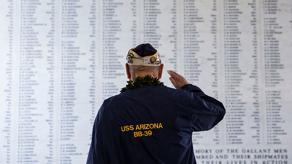 FILE - U.S.S. Arizona survivor Louis Conter salutes the remembrance wall of the U.S.S. Arizona during a memorial service for the 73rd anniversary of the attack on the U.S. naval base at Pearl harbor on Dec. 7, 2014, in Pearl Harbor, Hawaii. (Photo by Kent Nishimura/Getty Images)