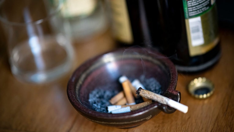 FILE - A joint sits in an ashtray next to beer bottles. (Photo by Fabian Sommer/picture alliance via Getty Images)