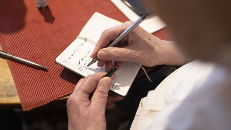 FILE - A person with dementia writes notes on Dec. 28, 2021 in Heidelberg, Germany. (Photo Illustration by Ute Grabowsky/Getty Images)