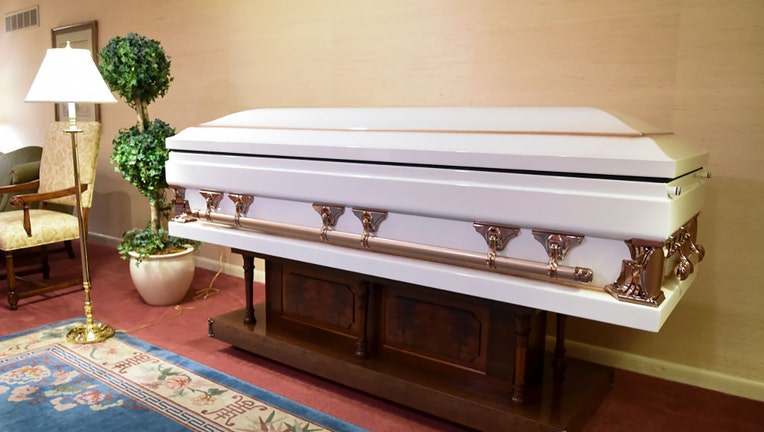 FILE - A white casket is pictured in a funeral home in 2021 (Photo by Ben Hasty/MediaNews Group/Reading Eagle via Getty Images)
