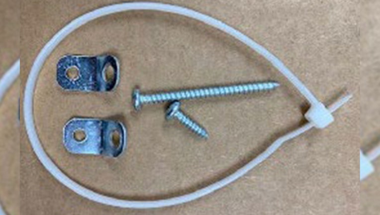 The recalled New Age tip restraint kit with plastic zip-tie, 2 brackets, and 2 screws. (Credit: U.S. Consumer Product Safety Commission)