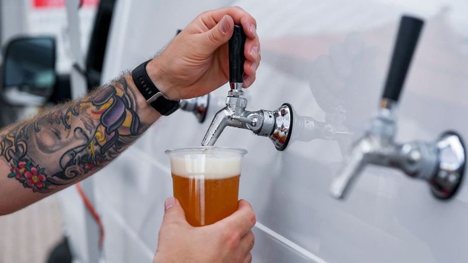 FILE - A person pours a beer for a customer on July 2, 2021, in Reading, Pennsylvania. (Photo by Ben Hasty/MediaNews Group/Reading Eagle via Getty Images)