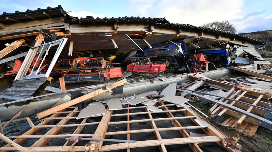 Agricultural machinery and other equipment are seen trapped under a collapsed wooden house in Wajima, Ishikawa prefecture on Jan. 2, 2024, a day after a major 7.5 magnitude earthquake struck the Noto region in Ishikawa prefecture in the afternoon. (Photo by KAZUHIRO NOGI/AFP via Getty Images)
