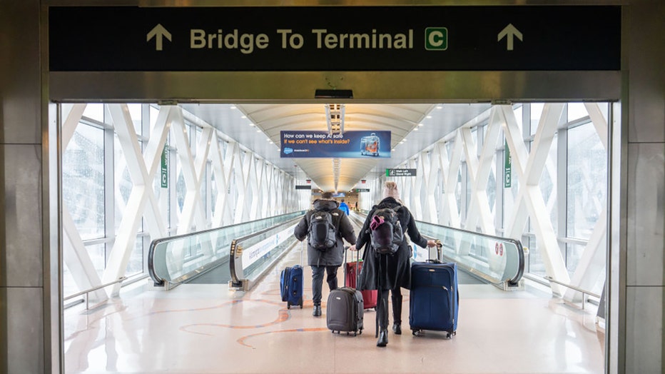 FILE - Travelers at Logan International Airport (BOS) in Boston, Massachusetts, US, on Jan. 7, 2024. Photographer: Mel Musto/Bloomberg via Getty Images