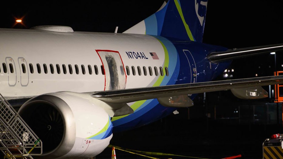 A plastic sheet covers an area of the fuselage of the Alaska Airlines N704AL Boeing 737 MAX 9 aircraft outside a hangar at Portland International Airport on Jan. 8, 2024, in Portland, Oregon. (Photo by Mathieu Lewis-Rolland/Getty Images)