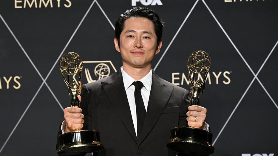 US actor Steven Yeun, winner of Outstanding Lead Actor In A Limited Or Anthology Series Or Movie and Outstanding Limited Or Anthology Series for "Beef," poses in the press room during the 75th Emmy Awards at the Peacock Theatre at L.A. Live in Los Angeles on January 15, 2024. (Photo by ROBYN BECK/AFP via Getty Images)