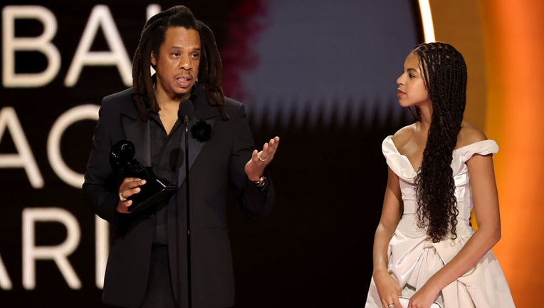 (LR) Honoree Jay-Z accepts the Dr. Dre Global Impact Award with Blue Ivy Carter onstage during the 66th GRAMMY Awards at Crypto.com Arena on Feb. 4, 2024, in Los Angeles, California. (Photo by Kevin Winter/Getty Images for The Recording Academy)