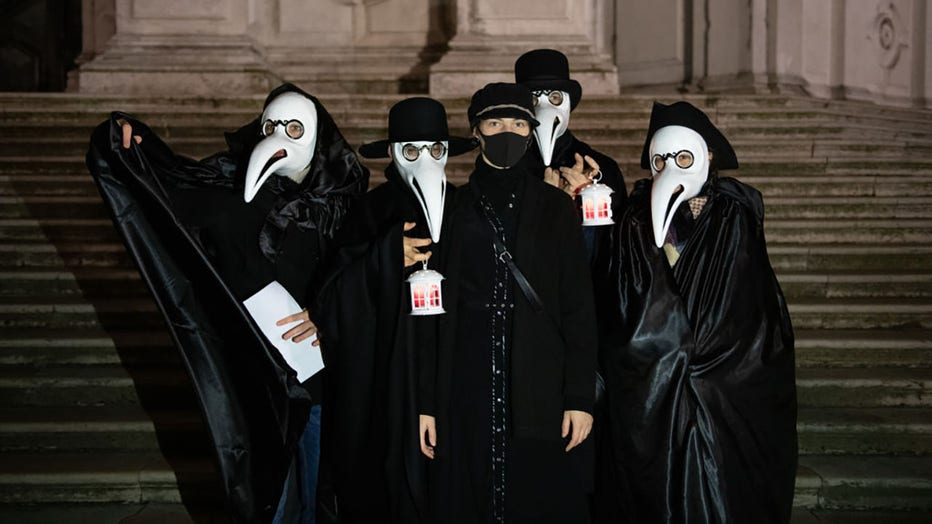 FILE - A group of Venetians dressed up like old doctors at the time when in Venice there was the plague celebrate the end of the Venice Carnival on Feb. 25, 2020 in Venice, Italy. (Photo by Giacomo Cosua/NurPhoto via Getty Images)